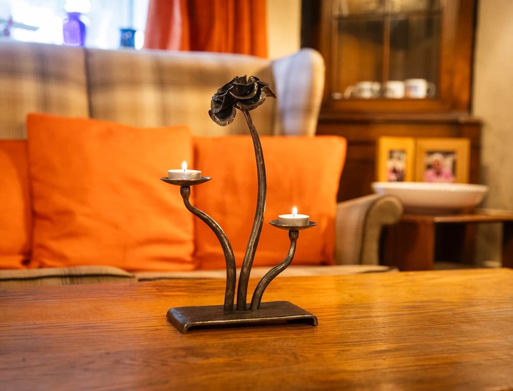 a cast iron rose tealight holder made on a blacksmith experience