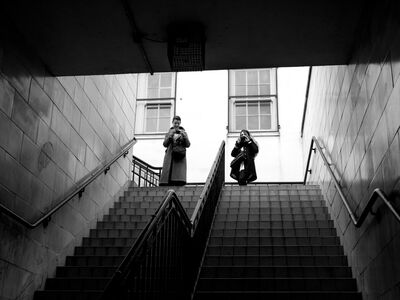 black and white photo of two people stood at the top of steps taken on a photography workshop with benson spiers