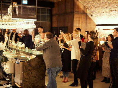 group of people raising glasses on a gin tasting experience in london