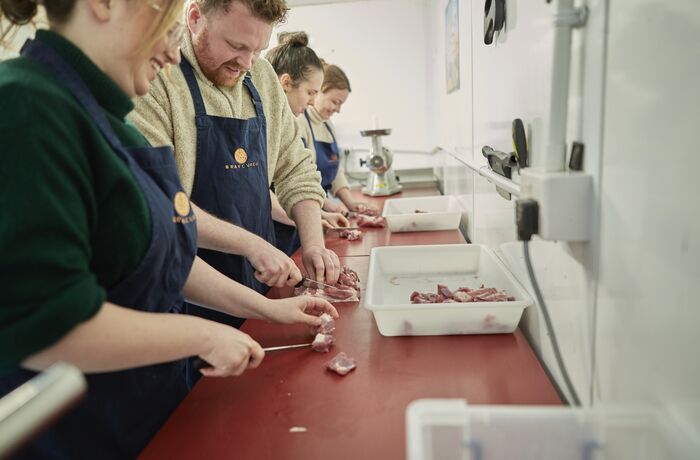learning butchery skills on a sausage making class