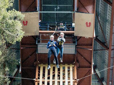 two people doing the plummet free fall experience at zip world