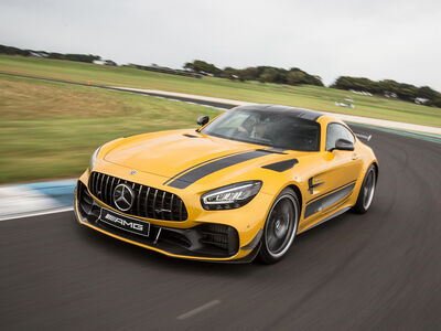 a yellow mercedes gtr on a race track during a driving experience day