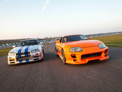 two movie inspired sports cars on a race track for a movie car track driving experience day