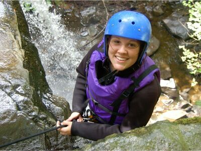 woman enjoying a canyoning descent experience day