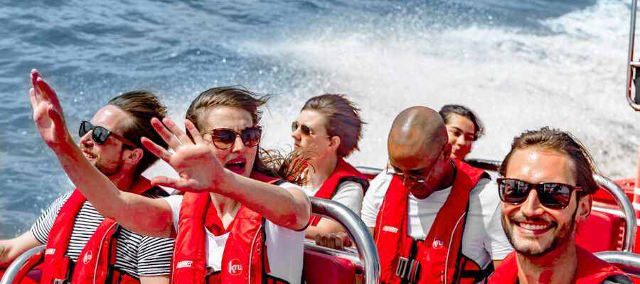 people enjoying a thames rocket speedboat experience on the thames in london