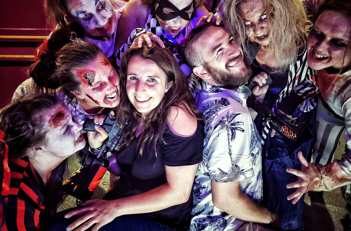 two people surrounded by zombies s part of a zombie birthday gift experience