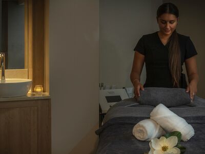 The spa therapist preparing the treatment room at the q hotels spa hotel in oxford