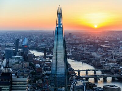 a view of the shard against the london skyline at sunset