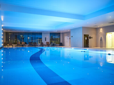 the indoor swimming pool lit up with blue lights at the crowne plaza hotel in reading