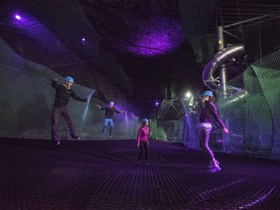 people bouncing on the trampolines underground at zip worlds bounce below