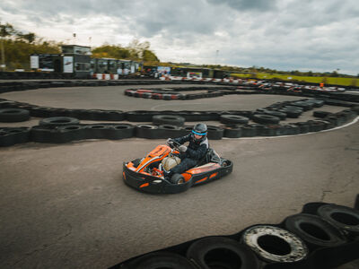 person racing in a go-kart around a track at midland karting