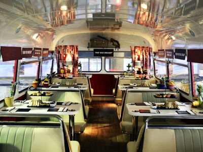 the interior of the red bus bistro set up for afternoon tea