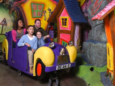 family of two adults and two children on one of the rides at cadbury world in birmingham