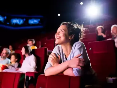 woman enjoying a film at the cinema with a cinema pass for up to six people
