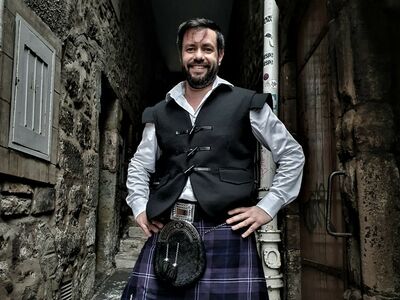 man dressed in traditional scottish dress as a highlander