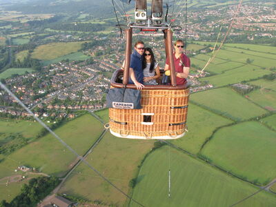 couple on a private hot air balloon ride with countryside views below